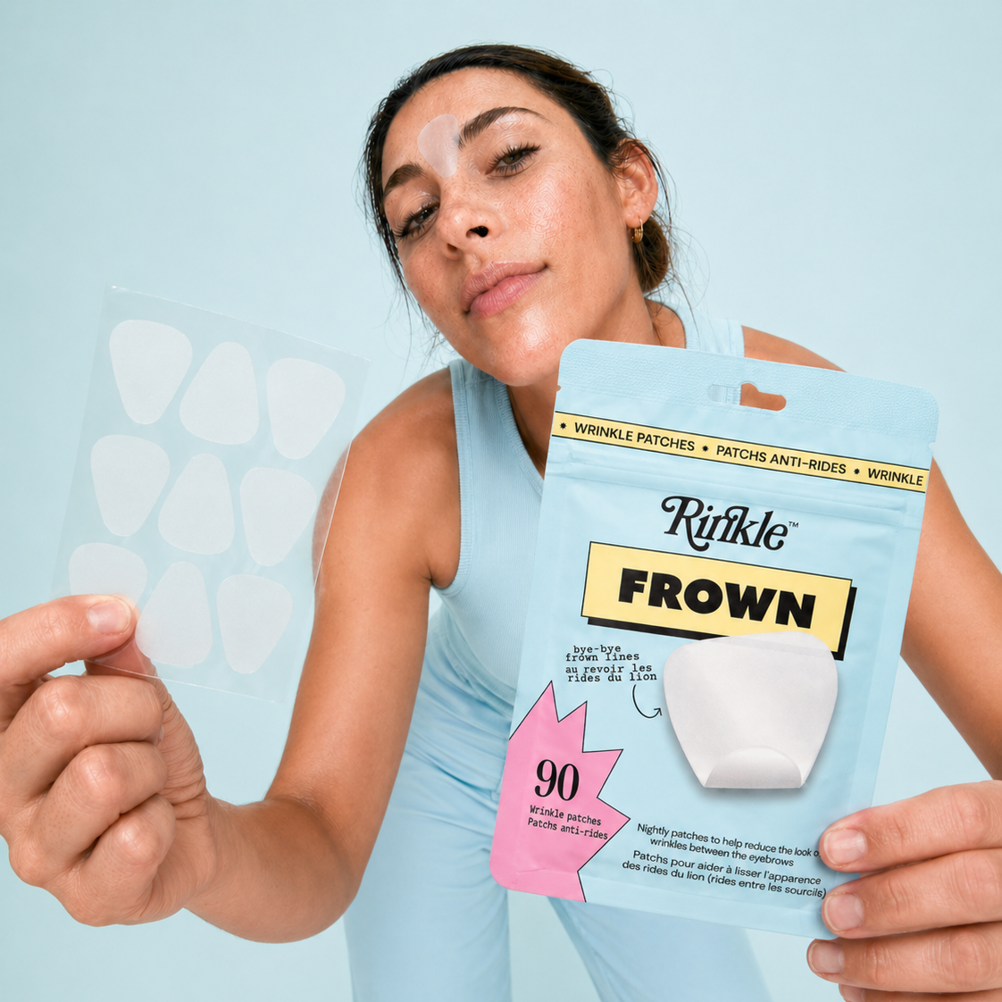 Woman holding a pouch of Rinkle Frown patches and a sheet of patches